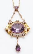 A 9ct gold amethyst and seed pearl fixed pendant necklace, central amethyst 14mm x 10mm, 47mm