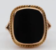 A 9ct gold onyx signet ring, T, 5.8g