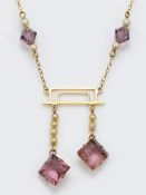 A gold seed pearl and synthetic amethyst fixed pendant necklace, 30mm drop, electronically tests