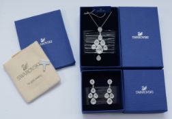 Swarovski, a Sensation drop necklace with matching chandelier earrings and a Swarovski cleaning