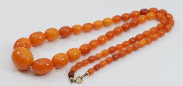 An amber beaded necklace, largest bead 25mm, 67cm, 41g