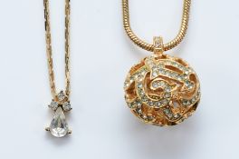 Christian Dior, a 1980s gilt metal open work sphere pendant on a chain, 62cm chain, 18mm sphere,