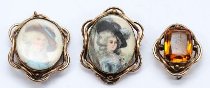 Two Victorian hand painted ivorine brooches, one missing its pin but has a pendant bail, with a