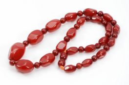 A cherry Bakelite beaded necklace, screw closure, 23mm largest bead, 44cm, 23g