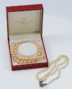 Two cultured pearl necklaces, to include a silver clasped version, 43-45cm