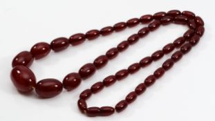 A cherry Bakelite beaded necklace, largest bead 25mm, screw closure, 71cm, 52g
