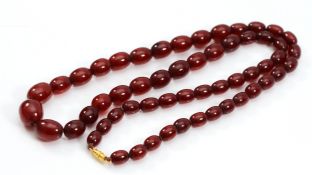 A cherry Bakelite beaded necklace, screw closure, largest bead 14mm, 62cm, 31g