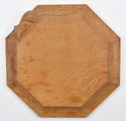 Robert 'Mouseman' Thompson of Kilburn, an adzed oak octagonal cheeseboard, carved mouse to the side,