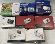 A collection of digital cameras to include, an Olympus FE-170, a Samsung WB850F and a Canon Power