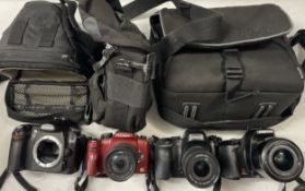 A collection of digital cameras to include, a Samsung NX30, a Panasonic Lumix G1 and a Nikon D56. (