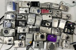 A collection of digital cameras to include, a Kodak DC 3400, a Minolta DiMage E201 and a Praktica