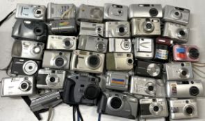 A collection of digital cameras to include, a Ricoh Caplio RR230, a HP Photosmart M417 and a Kodak