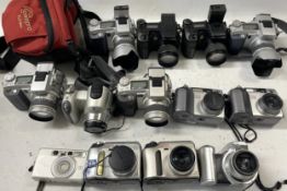 A collection of digital cameras to include, an Olympus C-720, an Olympus C-730 and a Minolta