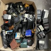 A collection of camera accessories to include, flash units, film, lens filters and light