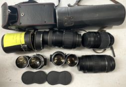 A box of camera lens to include a Yashica 1:5.6 300mm lens, a Sigma 1:4.5 70-210mm lens, a CanonEF