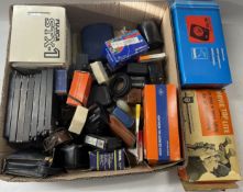 A Fujica STX-1 film camera with a box of accessories and attachments.