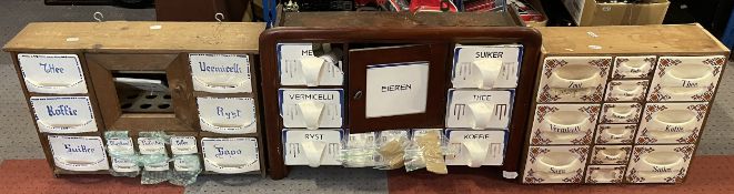 Three vintage wall-mounted wooden spice racks, with assorted ceramic drawers. Some damage and