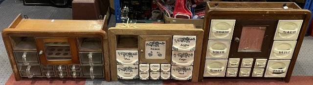 Three vintage wall-mounted spice racks, including ceramic and glass drawer examples. Some damage and