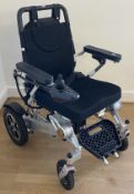 A 'Free To Be' electric wheelchair model NSDS 01-Silver, with charger and instruction manual, used