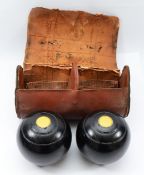 A cased pair of Crown Green bowls, each stamped 'R38'.