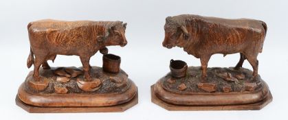 A pair of Black Forest carvings to include 1 cow and 1 bull, c.1900, in the style of Johann Huggler,