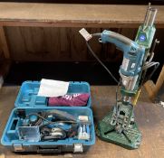 Two Makita power tools to include, a Makita hammer drill model number HP2071F mounted in a Record