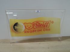Steiff Advertising Plaque, 50cm x 30cm, been attached to a wall with a drilled hole in each corner