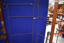 A wrought iron bi-fold frame,maximum height 187cm
