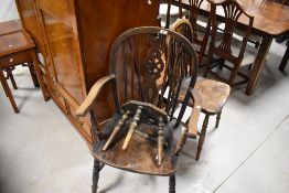 A traditional wheelback carver chair, similar kitchen chair and carved stool