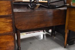 A 19th Century mahogany Pembroke style table having fluted legs