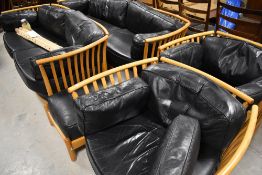 A vintage Ercol lounge suite in the comprising two settees and two chairs, together with similar