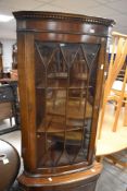 A reproduction corner display cupboard