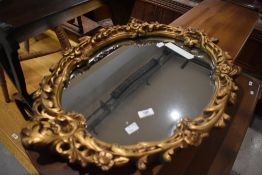 A vintage gilt plaster mirror of foliate design, approx. 67 x 50cm