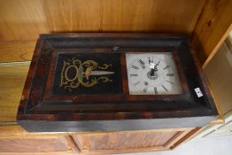 An American style wall clock printed Ansonia to interior of case