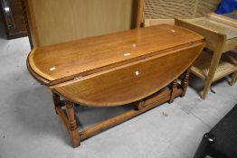 A modern oak drop leaf coffee table, width approx. 112cm