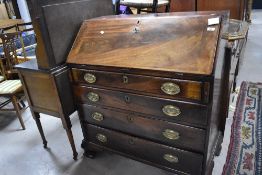 A 19th Century and later mahogany bureau having fitted interior under slop , with four long