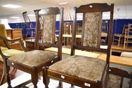 A set of four vintage 'New Plan' dining chairs having upholstered seats and backs