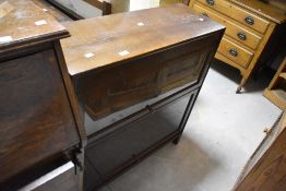 An early 20th Century oak sectional two tier bookcase, labelled Gunn, width approx. 87cm, height