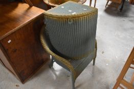 A vintage Lloyd Loom corner linen basket and tub chair