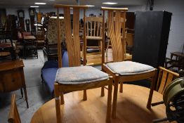 A vintage Ercol extending dining table and a set of six chairs in the Saville design