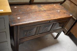 A period oak kist , having three carved panels , monogram SB, and dated 1678 (though probably a