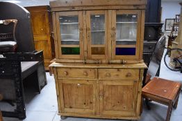 A traditional pine kitchen or similar dresser having glazed upper section, in the French style,