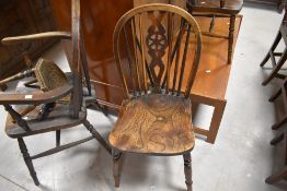 A traditional wheelback carver chair, childs size