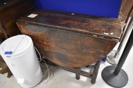 A period oak table having twist gateleg , approx width 107cm, closed depth 43cm