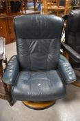 A Stressless chair having teal upholstery and wood effect frame