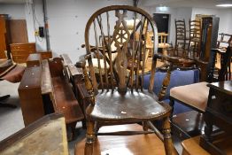 A vintage part oak wheelback carver chair