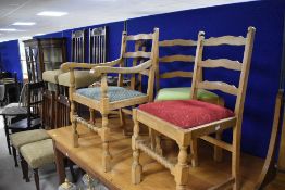 A set of four (three plus one) ladderback dining chairs , having drop in seats in three different