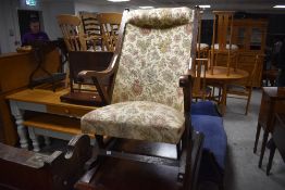 A traditional oak framed rocking chair, in the Victorian style