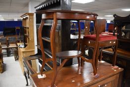 An early 20th Century mahogany occasional table having oval top and undertier, width approx. 75cm