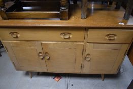 A Vintage Ercol sideboard having '2-1' formation on splay legs, width approx. 120cm